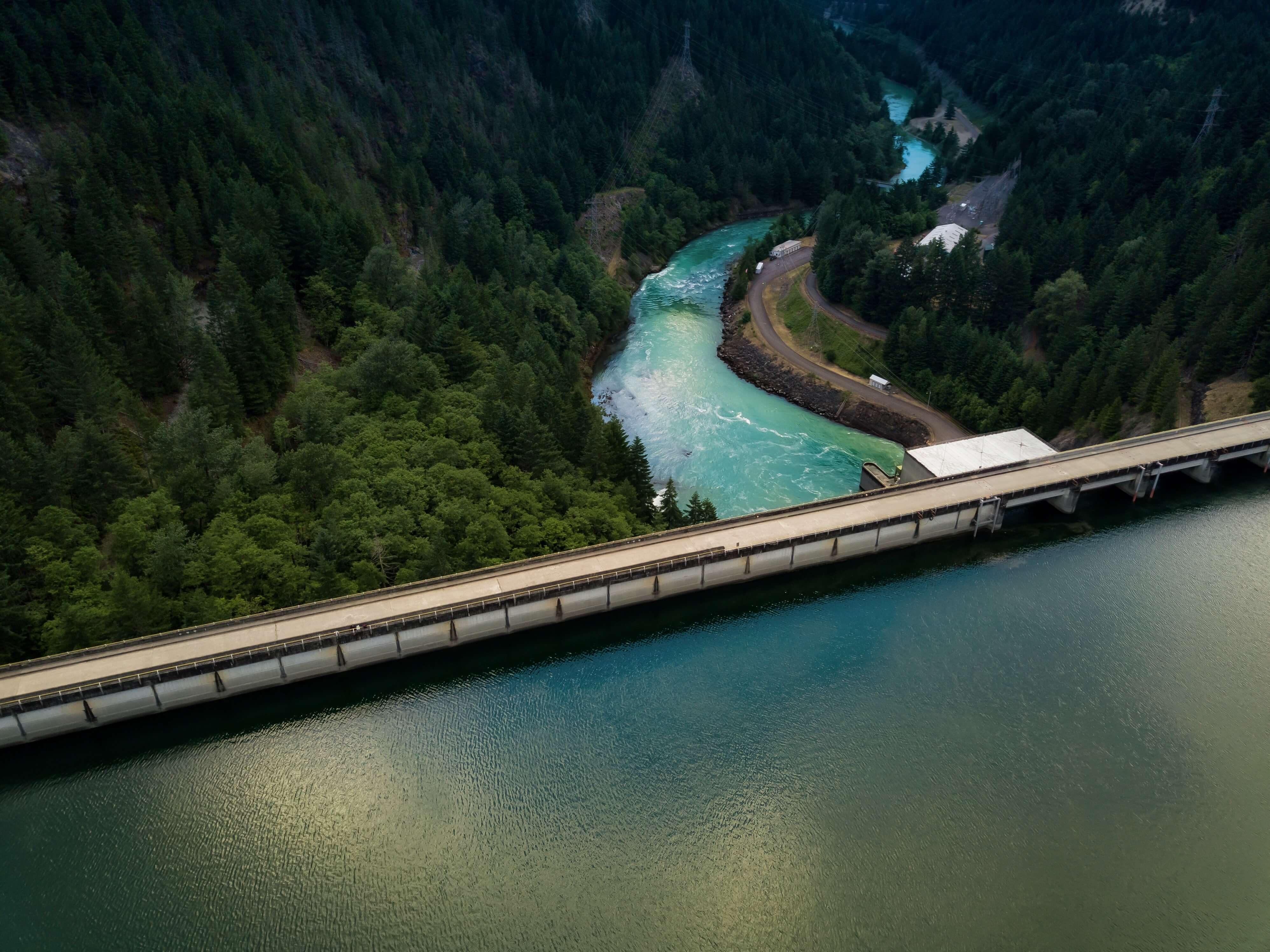 Dam with greenery and river flowing by