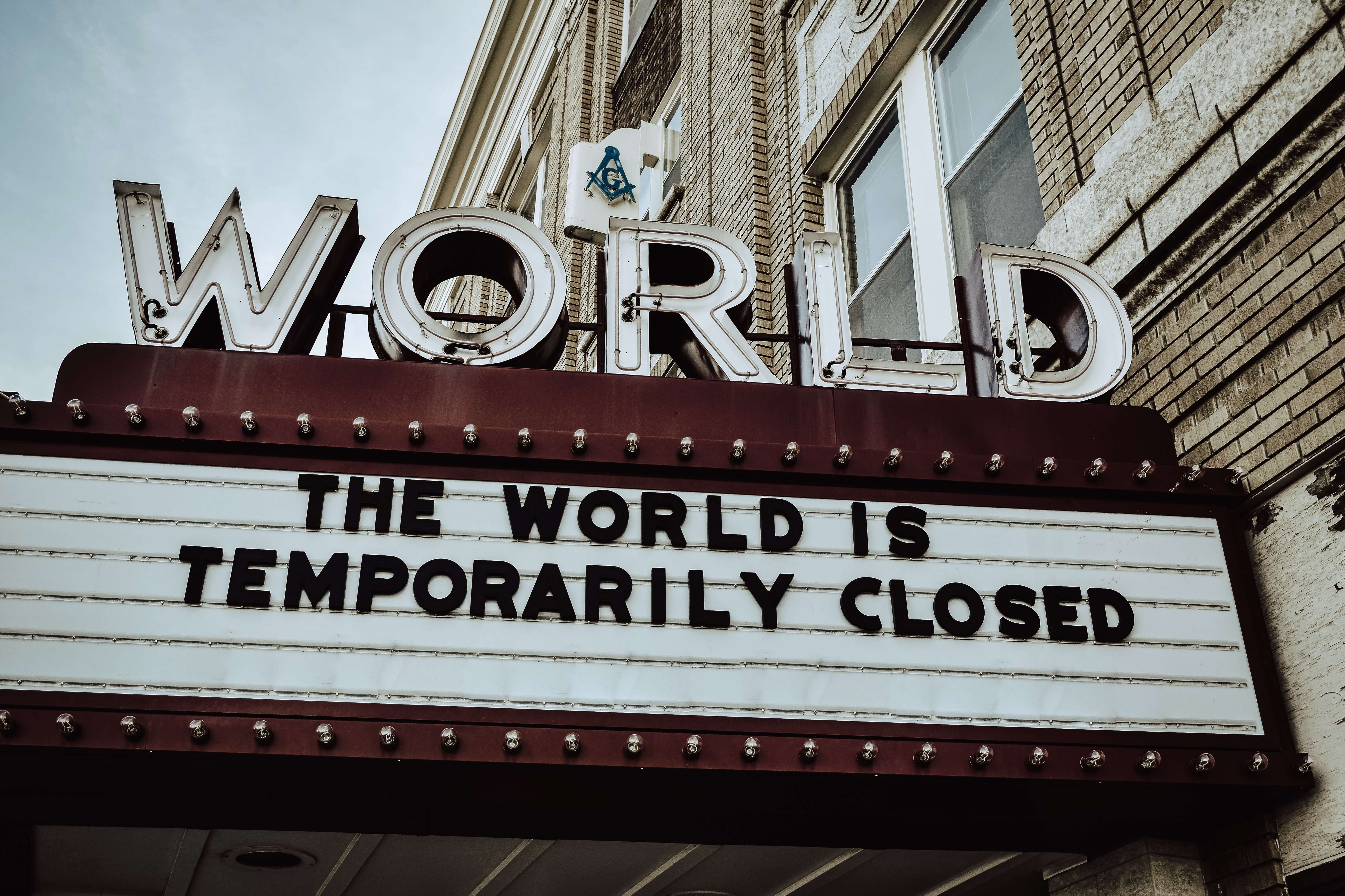 Movie theater sign which reads the world is temporarily closed